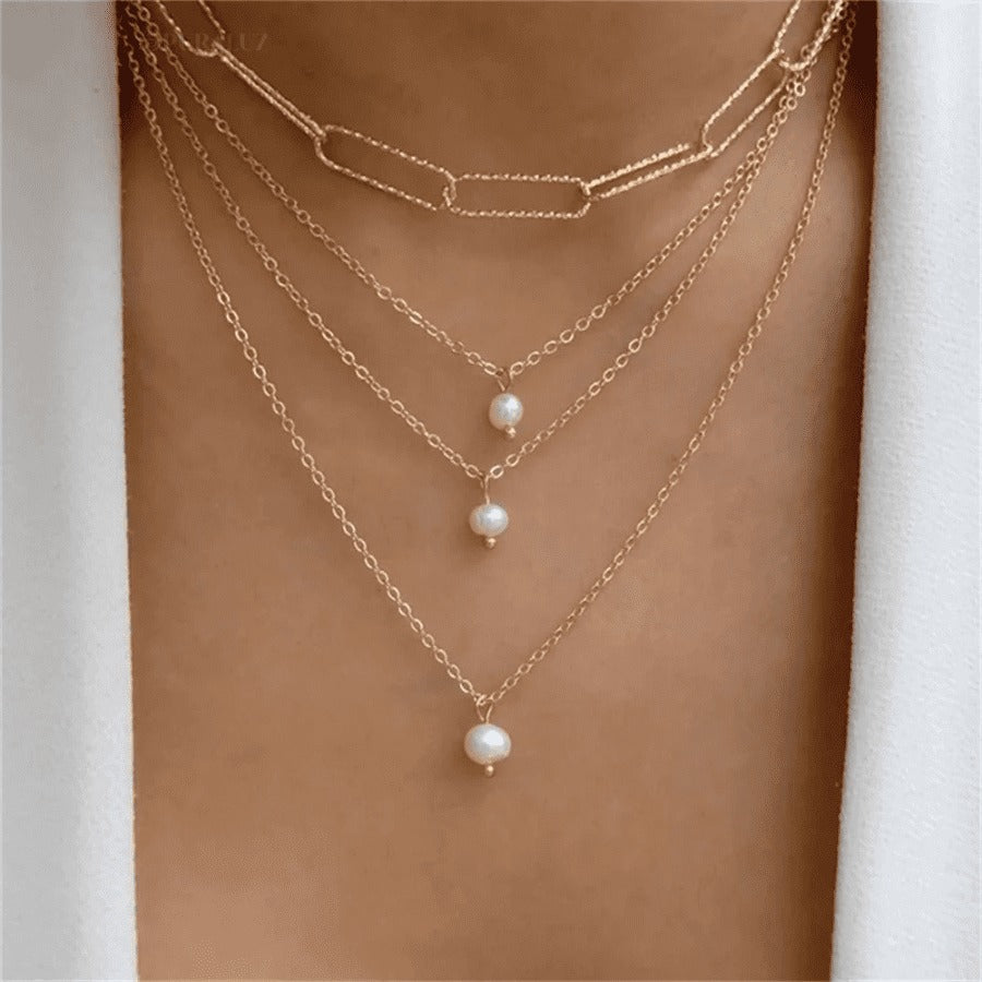 Divine necklace set; Pearl and crucifix jewelry; Elegant pearl necklaces; Stylish crucifix pendants; Handmade pearl jewelry; Christian faith necklaces; Unique pearl and crucifix design; Versatile necklace set; Fashionable religious jewelry; Statement pearl necklaces; Personalized crucifix necklaces; Luxurious pearl and gold jewelry; Spiritual symbolism necklaces; Layered pearl necklace set; Artisan-crafted crucifix jewelry; Gift for faith; Beautifully designed pearl necklaces; Modern crucifix jewelry;