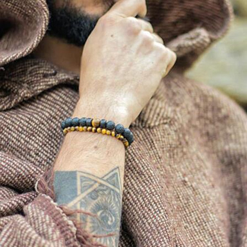 Tibetan bracelet; Volcanic lava stone bracelet; Handcrafted spiritual jewelry; Unique design for grounding and strength; Artisan-crafted accessory; Ethically sourced volcanic lava; Gift for those seeking stability; Stylish and rugged for everyday wear; Durable and fashionable; Beautifully textured lava beads; Unique spiritual gift; Bracelet for protection and emotional balance; Natural stones for personal empowerment; Lightweight and comfortable; Ideal for meditation practices;