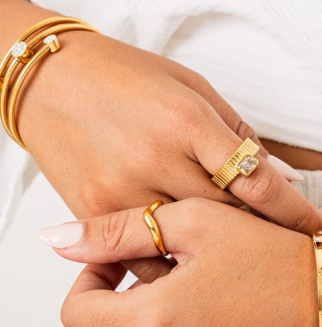 aspen ring; 18k gold-plated jewelry; elegant and modern design; stylish gold ring; luxury fashion accessory; high-quality craftsmanship; unique and eye-catching; perfect gift for her; sophisticated gold finish; versatile for any occasion; comfortable wear; contemporary elegance; durable gold plating; timeless style; statement ring; exquisite fashion piece; delicate and refined; fashionable and chic; trendy jewelry piece; unique design details;