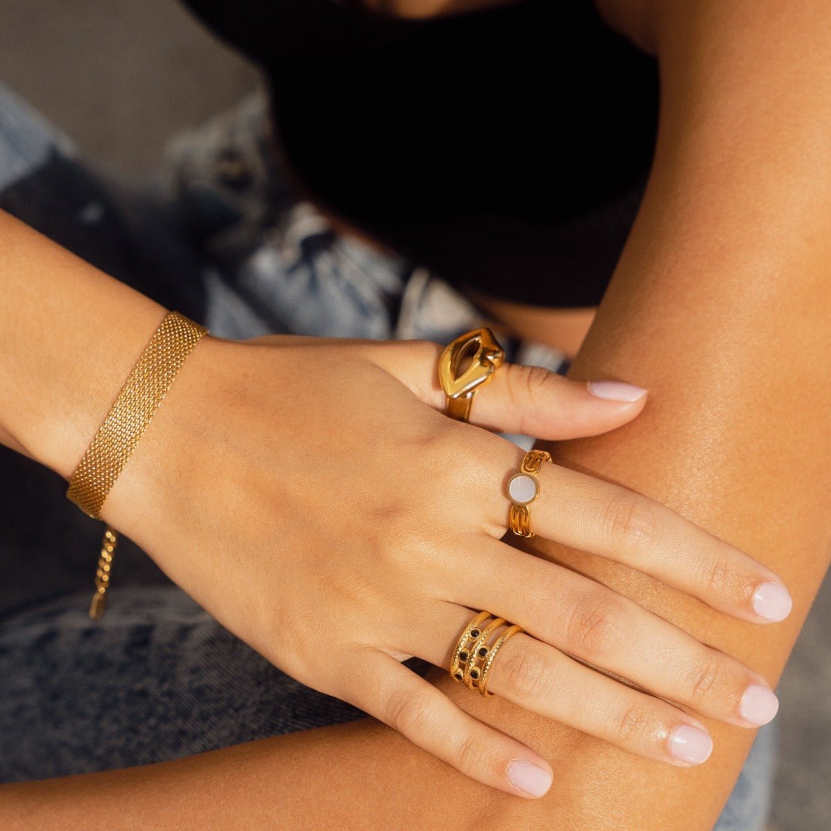 athena ring; mother-of-pearl stone; 18k gold-plated jewelry; elegant design; luxury ring for women; iridescent gemstone; high-quality craftsmanship; unique and sophisticated; perfect gift for any occasion; timeless elegance; exquisite fashion accessory; delicate and refined style; versatile for everyday wear; stunning gold finish; contemporary and chic; crafted with care; eye-catching fashion piece; unique design details; enchanting beauty;