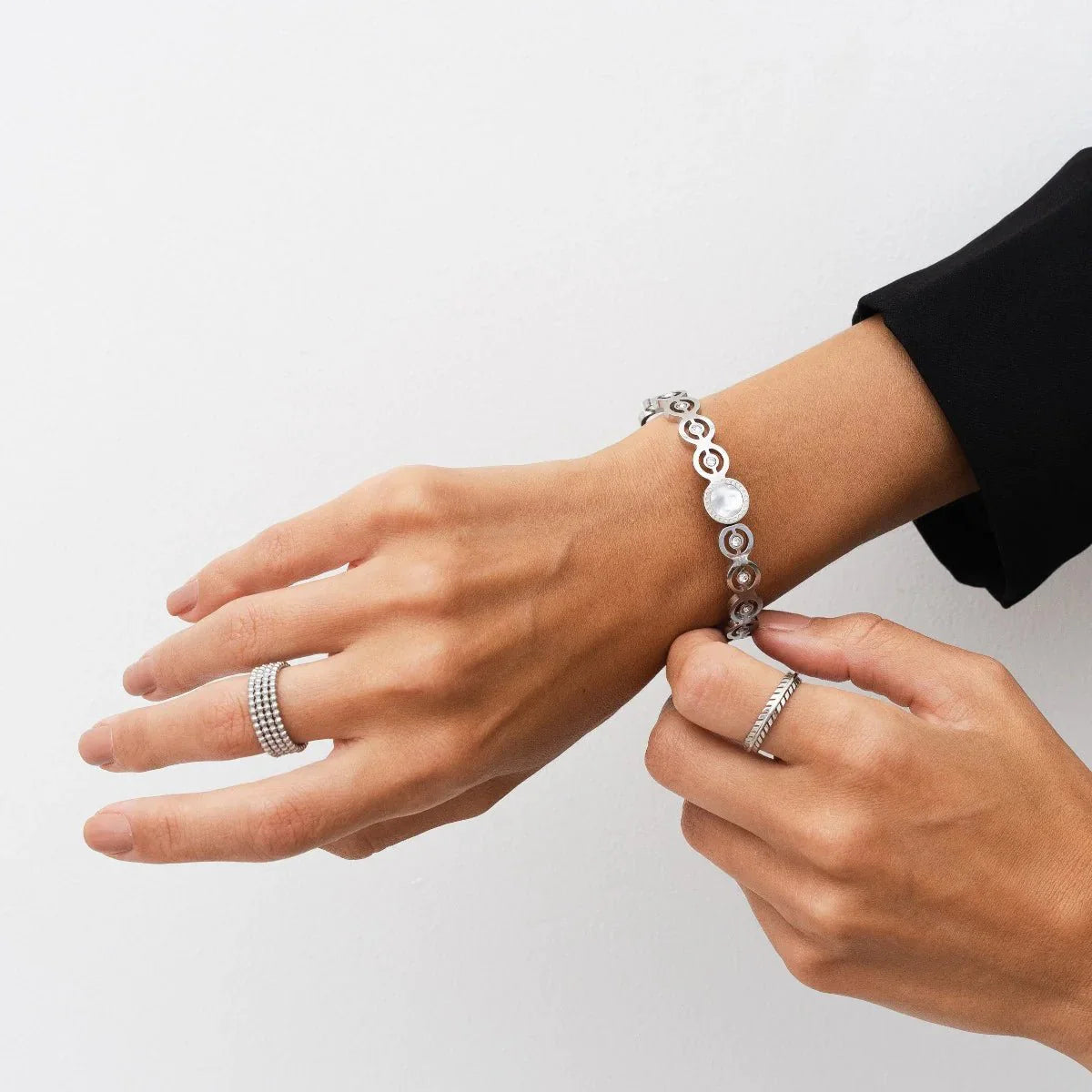 iconic spheres ring; silver jewelry; modern design ring; unique statement piece; elegant silver accessory; high-quality craftsmanship; stylish and contemporary; perfect gift for her; versatile wear; minimalist aesthetic; timeless elegance; chic fashion ring; adjustable fit; eye-catching spheres; sophisticated and sleek; luxurious appearance; refined beauty; intricate detailing; fashionable silver ring; unique gift idea; perfect for special occasions;