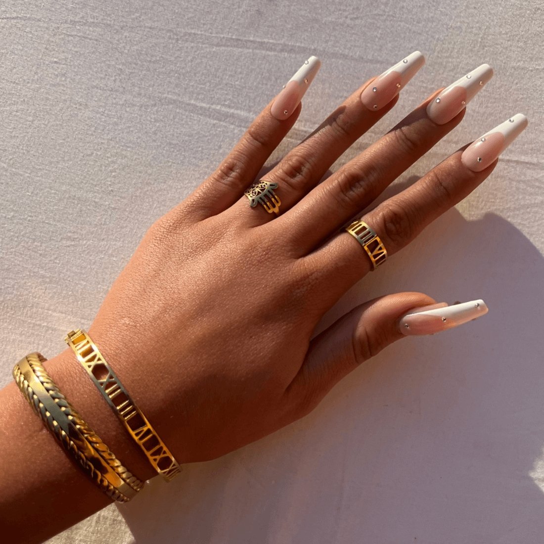 roman numeral ring; 18k gold plated jewelry; timeless design ring; elegant statement piece; classic gold accessory; high-quality craftsmanship; unique gift for her; versatile fashion ring; sophisticated gold finish; minimalist style; luxurious appearance; meaningful design; adjustable fit; perfect for any occasion; stylish and trendy; eye-catching numeral details; chic and elegant; handmade quality; fashionable gold ring; perfect for layering; trendy gold accessory; everyday elegance; unique gift idea;
