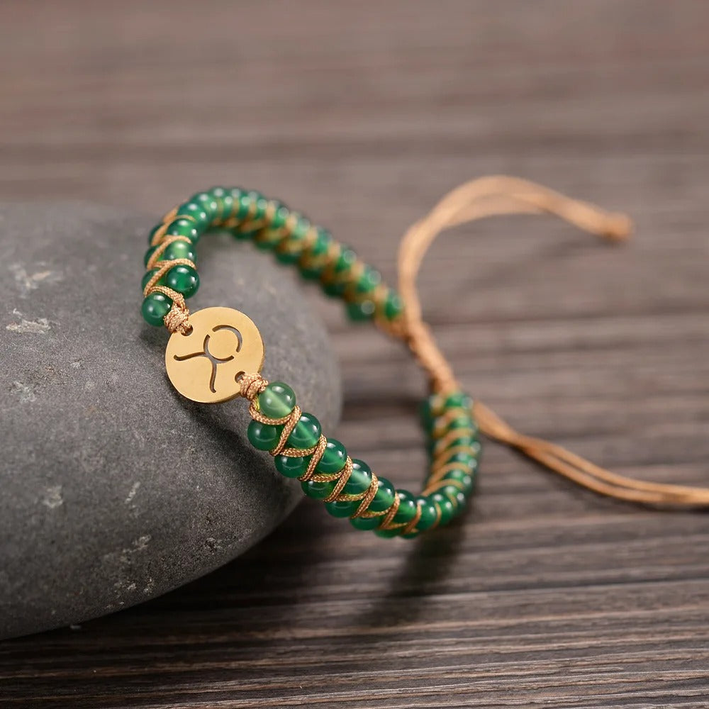 Zodiac bracelet; Braided design; Handcrafted zodiac jewelry; Unique astrological accessory; Artisan-crafted bracelet; Ethically sourced materials; Gift for astrology enthusiasts; Stylish and comfortable for daily wear; Beautiful braided details; Personalized zodiac sign representation; Perfect for layering with other bracelets; Unique spiritual gift; Bracelet for intention setting; Durable and fashionable design; Ideal for any occasion; Symbol of celestial connection;