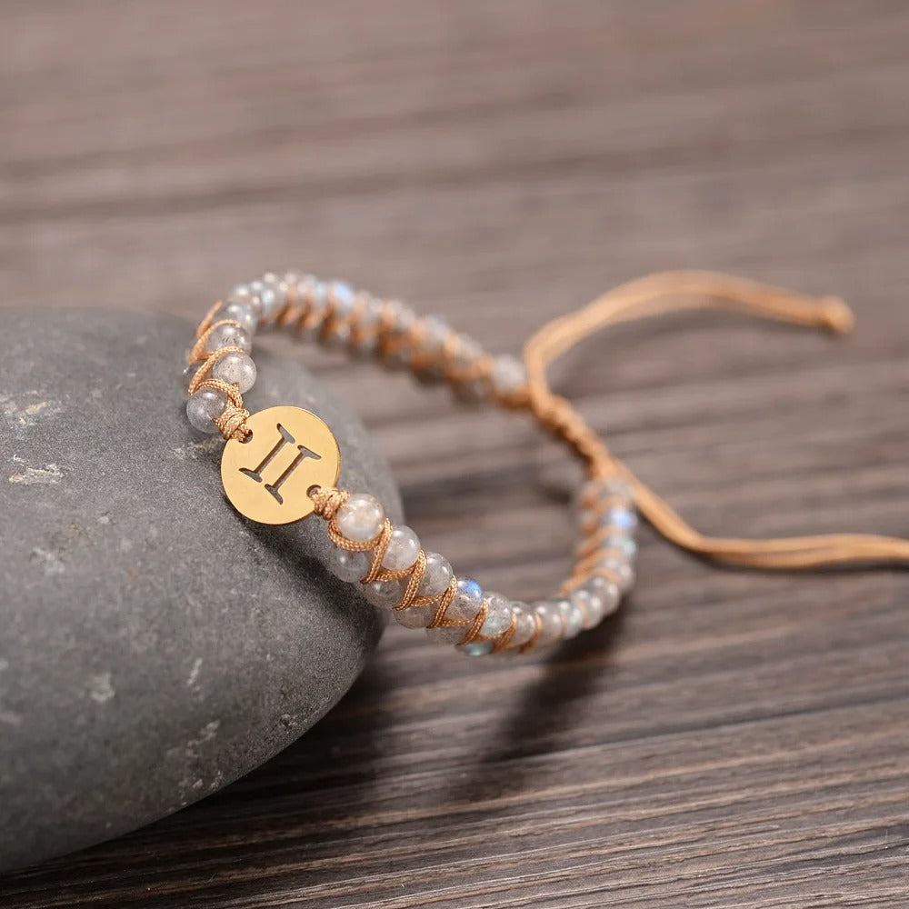 Zodiac bracelet; Braided design; Handcrafted zodiac jewelry; Unique astrological accessory; Artisan-crafted bracelet; Ethically sourced materials; Gift for astrology enthusiasts; Stylish and comfortable for daily wear; Beautiful braided details; Personalized zodiac sign representation; Perfect for layering with other bracelets; Unique spiritual gift; Bracelet for intention setting; Durable and fashionable design; Ideal for any occasion; Symbol of celestial connection;
