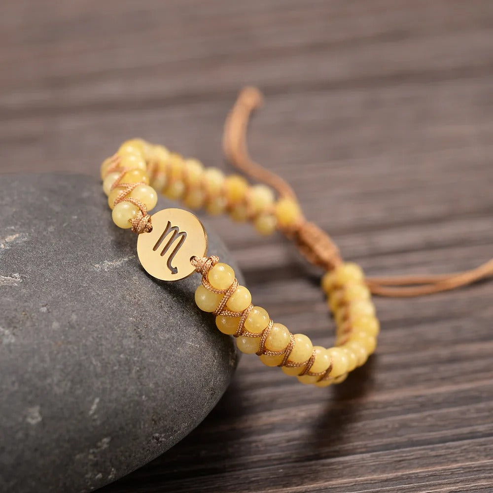 Zodiac bracelet; Braided design; Handcrafted zodiac jewelry; Unique astrological accessory; Artisan-crafted bracelet; Ethically sourced materials; Gift for astrology enthusiasts; Stylish and comfortable for daily wear; Beautiful braided details; Personalized zodiac sign representation; Perfect for layering with other bracelets; Unique spiritual gift; Bracelet for intention setting; Durable and fashionable design; Ideal for any occasion; Symbol of celestial connection;