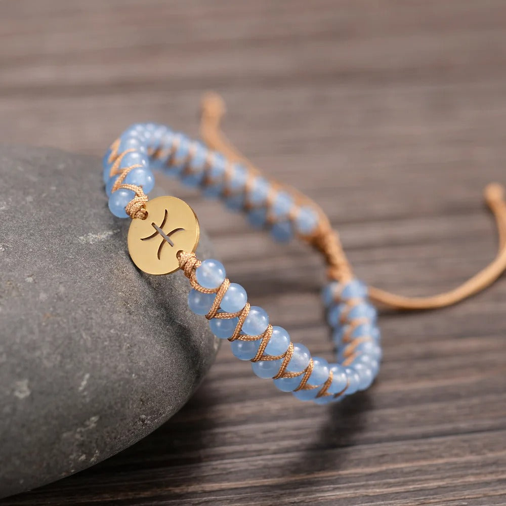 Zodiac bracelet; Braided design; Handcrafted zodiac jewelry; Unique astrological accessory; Artisan-crafted bracelet; Ethically sourced materials; Gift for astrology enthusiasts; Stylish and comfortable for daily wear; Beautiful braided details; Personalized zodiac sign representation; Perfect for layering with other bracelets; Unique spiritual gift; Bracelet for intention setting; Durable and fashionable design; Ideal for any occasion; Symbol of celestial connection;
