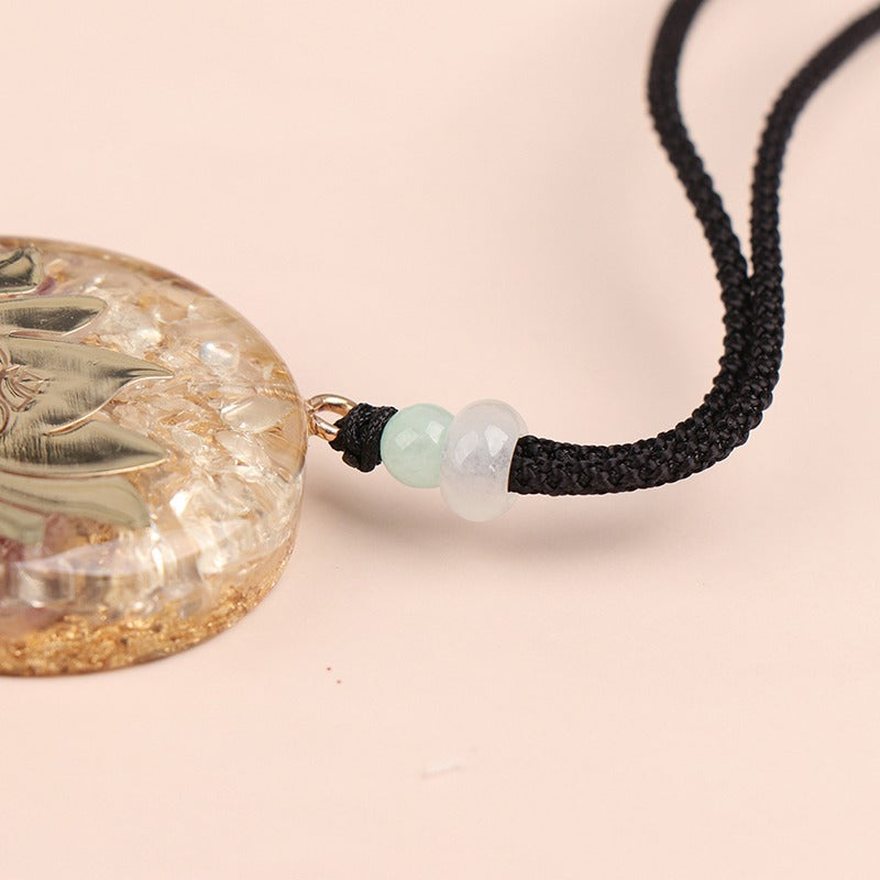 Orgonite lotus flower necklace; Handcrafted spiritual jewelry; Unique design symbolizing purity and enlightenment; Artisan-crafted accessory; Ethically sourced materials; Gift for those seeking peace and spiritual growth; Stylish and meaningful for everyday wear; Durable and fashionable; Beautifully detailed lotus flower for spiritual connection; Unique spiritual gift; Necklace for enhancing positive energy and protection; Natural elements for emotional healing and balance;