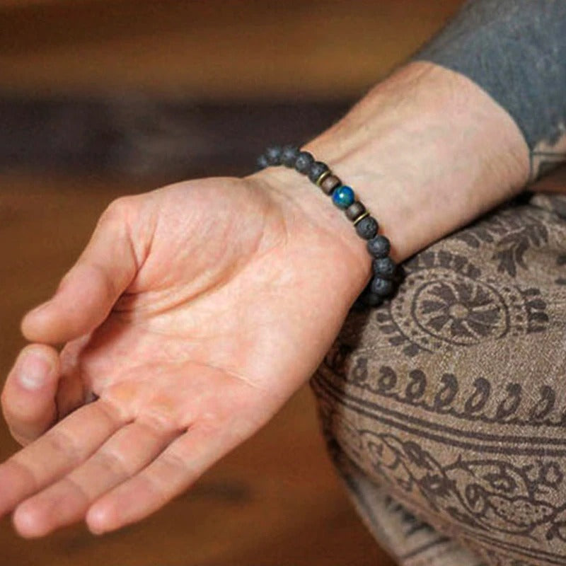 Tibetan bracelet; Volcanic lava stone bracelet; Handcrafted spiritual jewelry; Unique design for grounding and strength; Artisan-crafted accessory; Ethically sourced volcanic lava; Gift for those seeking stability; Stylish and rugged for everyday wear; Durable and fashionable; Beautifully textured lava beads; Unique spiritual gift; Bracelet for protection and emotional balance; Natural stones for personal empowerment; Lightweight and comfortable; Ideal for meditation practices;