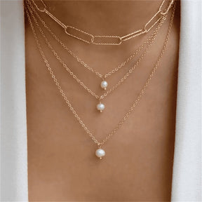 Divine necklace set; Pearl and crucifix jewelry; Elegant pearl necklaces; Stylish crucifix pendants; Handmade pearl jewelry; Christian faith necklaces; Unique pearl and crucifix design; Versatile necklace set; Fashionable religious jewelry; Statement pearl necklaces; Personalized crucifix necklaces; Luxurious pearl and gold jewelry; Spiritual symbolism necklaces; Layered pearl necklace set; Artisan-crafted crucifix jewelry; Gift for faith; Beautifully designed pearl necklaces; Modern crucifix jewelry; 