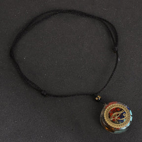 Horus Eye orgonite necklace; Handcrafted spiritual jewelry; Unique design symbolizing protection and insight; Artisan-crafted accessory; Ethically sourced materials; Gift for spiritual seekers and enthusiasts; Stylish and meaningful for everyday wear; Durable and fashionable; Beautifully detailed Eye of Horus symbol; Necklace for enhancing positive energy and protection; Natural elements for emotional balance and healing; Lightweight and comfortable;