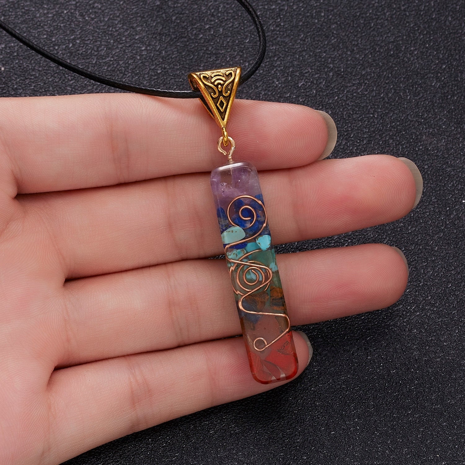 Orgonite energy flow necklace; 7 chakras amulet for balance; Enhances energy flow and healing; Unique blend of natural crystals and resin; Promotes emotional well-being and harmony; Beautifully crafted for everyday wear; Supports spiritual growth and protection; Ideal gift for holistic health enthusiasts; Handcrafted with care and intention; Vibrant colors representing each chakra; Lightweight and comfortable design;