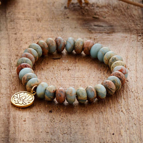 Imperial Jasper lotus flower bracelet; Handcrafted gemstone jewelry; Unique lotus flower design; Artisan-crafted spiritual accessory; Natural Imperial Jasper stones; Symbol of purity and enlightenment; Bracelet for mindfulness and balance; Gift for spiritual enthusiasts; Healing energy bracelet; Beautifully detailed lotus charm; Unique spiritual gift; Bracelet for intention setting; Natural stones for emotional stability; Stylish and meaningful jewelry; Durable and fashionable design; Perfect for daily wear