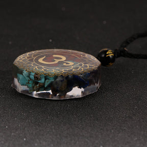 Orgonite OM necklace; Handcrafted spiritual jewelry; Unique design for energy protection and balance; Artisan-crafted accessory; Ethically sourced materials; Gift for meditation and mindfulness enthusiasts; Stylish and meaningful for everyday wear; Durable and fashionable; Beautifully detailed OM symbol for spiritual connection; Unique spiritual gift; Necklace for enhancing personal energy and harmony; Natural elements for emotional healing and grounding;