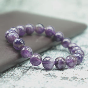 Harmony bracelet; Amethyst stone bracelet; Handcrafted gemstone jewelry; Unique design for balance; Artisan-crafted accessory; Ethically sourced amethyst; Gift for spiritual enthusiasts; Stylish and elegant for everyday wear; Durable and fashionable; Beautifully arranged amethyst beads; Unique spiritual gift; Bracelet for mindfulness and tranquility; Natural stones for emotional stability; Lightweight and comfortable; Ideal for layering with other bracelets;