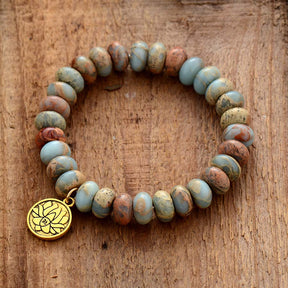 Imperial Jasper lotus flower bracelet; Handcrafted gemstone jewelry; Unique lotus flower design; Artisan-crafted spiritual accessory; Natural Imperial Jasper stones; Symbol of purity and enlightenment; Bracelet for mindfulness and balance; Gift for spiritual enthusiasts; Healing energy bracelet; Beautifully detailed lotus charm; Unique spiritual gift; Bracelet for intention setting; Natural stones for emotional stability; Stylish and meaningful jewelry; Durable and fashionable design; Perfect for daily wear