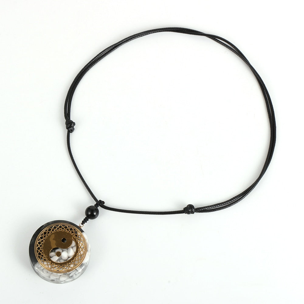 Yin Yang orgonite necklace; Handcrafted spiritual jewelry; Unique design for balancing energies; Artisan-crafted accessory; Ethically sourced materials; Gift for those seeking harmony and balance; Stylish and meaningful for everyday wear; Durable and fashionable; Beautifully detailed Yin Yang symbol for duality and unity; Unique spiritual gift; Necklace for enhancing energy flow and protection; Natural elements for emotional healing and grounding;