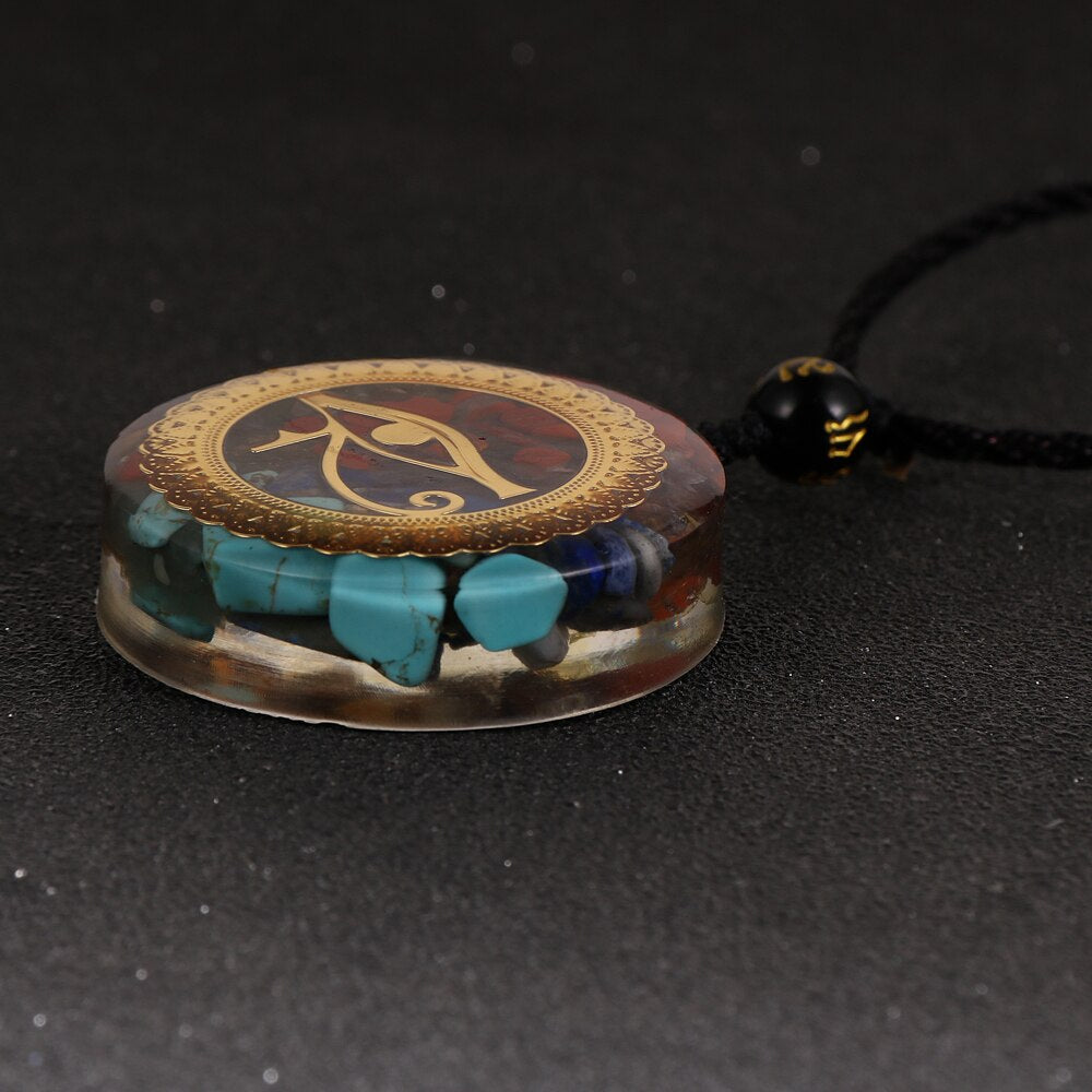 Horus Eye orgonite necklace; Handcrafted spiritual jewelry; Unique design symbolizing protection and insight; Artisan-crafted accessory; Ethically sourced materials; Gift for spiritual seekers and enthusiasts; Stylish and meaningful for everyday wear; Durable and fashionable; Beautifully detailed Eye of Horus symbol; Necklace for enhancing positive energy and protection; Natural elements for emotional balance and healing; Lightweight and comfortable;