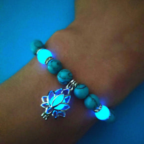 Glowing lotus flower bracelet; Handcrafted floral jewelry; Unique design symbolizing purity and enlightenment; Artisan-crafted accessory; Ethically sourced materials; Gift for spiritual seekers; Stylish and luminous for everyday wear; Durable and fashionable; Beautifully detailed lotus flower charm; Unique spiritual gift; Bracelet for personal growth and transformation; Natural stones for emotional healing; Lightweight and comfortable; Ideal for layering with other bracelets;