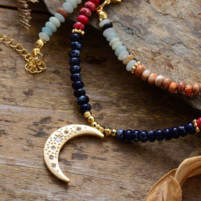 Chakra colors moon necklace; Natural stone necklace with imperial jasper; Enhances chakra alignment and balance; Beautifully designed moon pendant; Supports emotional healing and well-being; Unique blend of colors for each chakra; Ideal gift for spiritual and wellness enthusiasts; Handcrafted with care and attention; Lightweight and comfortable for everyday wear; Perfect for layering with other necklaces;