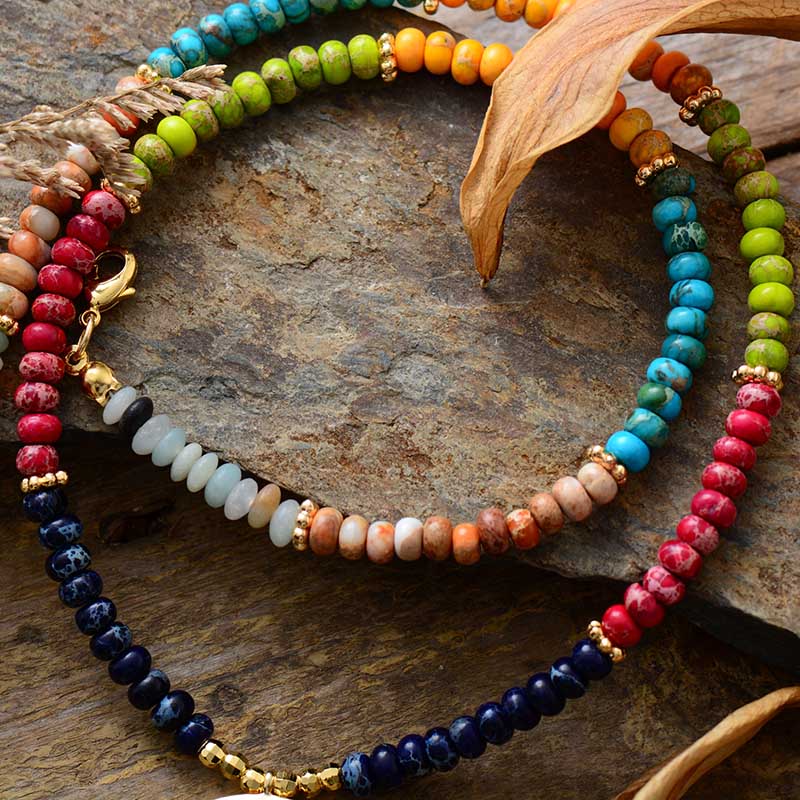 Chakra colors moon necklace; Natural stone necklace with imperial jasper; Enhances chakra alignment and balance; Beautifully designed moon pendant; Supports emotional healing and well-being; Unique blend of colors for each chakra; Ideal gift for spiritual and wellness enthusiasts; Handcrafted with care and attention; Lightweight and comfortable for everyday wear; Perfect for layering with other necklaces;