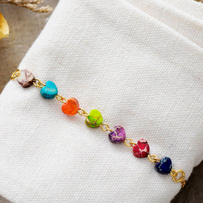 Chakra energy bracelet; Handcrafted gemstone jewelry; Unique design for balancing chakras; Artisan-crafted accessory; Ethically sourced materials; Gift for spiritual wellness enthusiasts; Stylish and colorful for everyday wear; Durable and fashionable; Beautifully polished stones representing each chakra; Unique spiritual gift; Bracelet for enhancing energy flow and emotional balance; Natural stones for healing and grounding; Lightweight and comfortable;