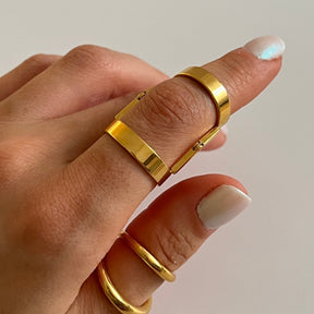 adjustable ring; articulated ring; 18k gold plated ring; elegant adjustable jewelry; versatile gold ring; luxury gold accessory; adjustable fit; stylish and unique design; perfect for every finger; fashion-forward ring; modern gold ring; high-quality gold finish; perfect gift for her; minimalist yet bold; durable and adjustable; chic and comfortable; everyday elegance; sophisticated and trendy; statement jewelry; gold-plated perfection; handcrafted jewelry; 