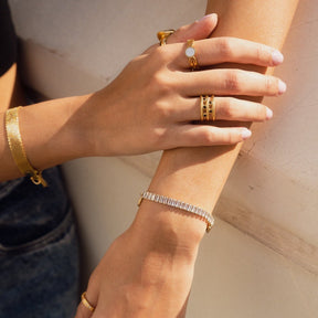 athena ring; mother-of-pearl stone; 18k gold-plated jewelry; elegant design; luxury ring for women; iridescent gemstone; high-quality craftsmanship; unique and sophisticated; perfect gift for any occasion; timeless elegance; exquisite fashion accessory; delicate and refined style; versatile for everyday wear; stunning gold finish; contemporary and chic; crafted with care; eye-catching fashion piece; unique design details; enchanting beauty;