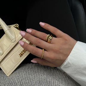 Trinity ring; 18K gold-plated Trinity ring; Gold-plated Trinity design; 18K gold ring; Trinity gold ring; Gold-plated fashion ring; Elegant Trinity ring; 18K gold-plated jewelry; Classic Trinity ring; Stylish gold-plated ring; Minimalist Trinity ring; Timeless Trinity design; Gold fashion jewelry; 18K gold statement ring; Triple band Trinity ring; Sophisticated gold ring;