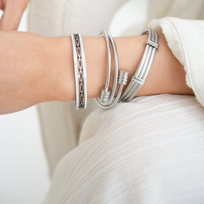 Silver bracelet; elegant accessory; discreet luxury; sophisticated fashion; refined style; silver shine; delicate jewellery; luxurious detail; elegant design; impeccable finish; perfect gift; timeless fashion; versatile accessory; classic beauty; subtle glamour; feminine style; high quality; exclusive piece; silver charm; touch of elegance.