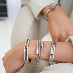 Silver bracelet; elegant accessory; discreet luxury; sophisticated fashion; refined style; silver shine; delicate jewellery; luxurious detail; elegant design; impeccable finish; perfect gift; timeless fashion; versatile accessory; classic beauty; subtle glamour; feminine style; high quality; exclusive piece; silver charm; touch of elegance.