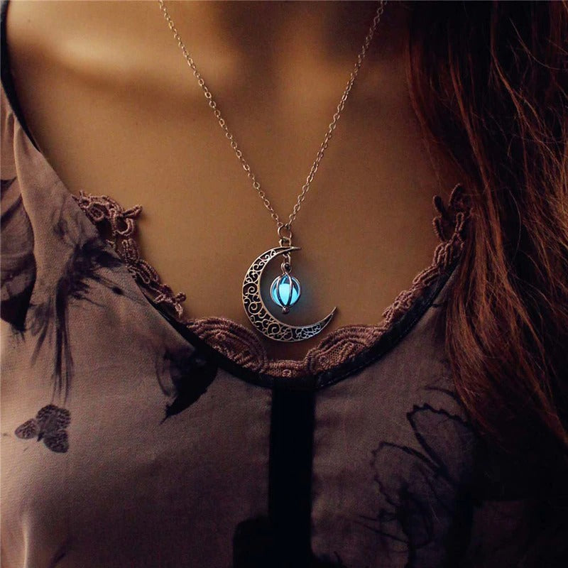 Luminous moon pendant necklace; Glows in the dark jewelry; Moon-inspired glowing necklace; Unique celestial necklace design; Captures the magic of the night sky; Perfect gift for moon lovers; Ethereal glow in the dark pendant; Handcrafted luminous jewelry; Stylish accessory for day or night; Symbol of mystery and elegance; Adds a touch of celestial beauty;