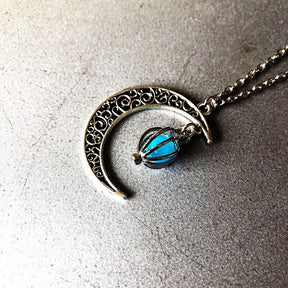 Luminous moon pendant necklace; Glows in the dark jewelry; Moon-inspired glowing necklace; Unique celestial necklace design; Captures the magic of the night sky; Perfect gift for moon lovers; Ethereal glow in the dark pendant; Handcrafted luminous jewelry; Stylish accessory for day or night; Symbol of mystery and elegance; Adds a touch of celestial beauty;