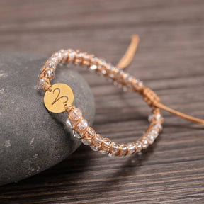 Zodiac bracelet; Braided design; Handcrafted zodiac jewelry; Unique astrological accessory; Artisan-crafted bracelet; Ethically sourced materials; Gift for astrology enthusiasts; Stylish and comfortable for daily wear; Beautiful braided details; Personalized zodiac sign representation; Perfect for layering with other bracelets; Unique spiritual gift; Bracelet for intention setting; Durable and fashionable design; Ideal for any occasion; Symbol of celestial connection; 