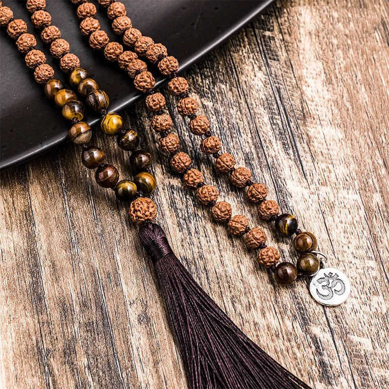 Rudraksha japamala; Tiger Eye beads mala; Handcrafted prayer beads; Unique meditation necklace; Spiritual jewelry; Gift with free bracelet; Artisan-crafted japamala; Natural stone beads; Japamala for mindfulness; Ethically sourced materials; Japamala for mantra repetition; Beautiful beaded necklace; Unique spiritual gift; Calming meditation accessory; Rudraksha for spiritual growth; Tiger Eye for protection; Japamala for intention setting; Stylish spiritual accessory;